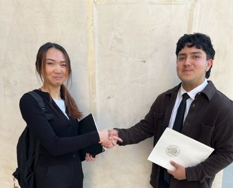 Tracy Trinh (left) and Karim Berdeja (right) practicing their handshake. 