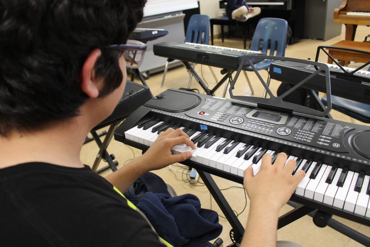 Music student practices the piano.