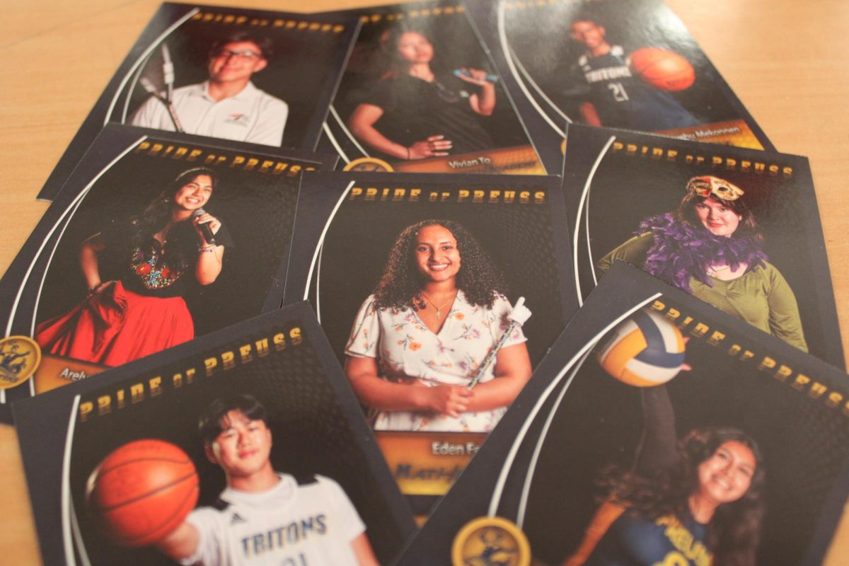 Pride of Preuss Seniors pose and represent each of their extracurricular activities for their photo cards. 
