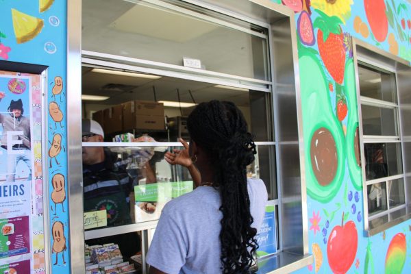 Middle school student receiving their lunch  