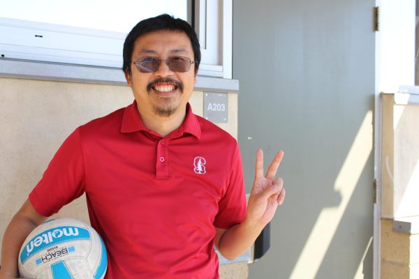 Mr. Hua holding a volleyball