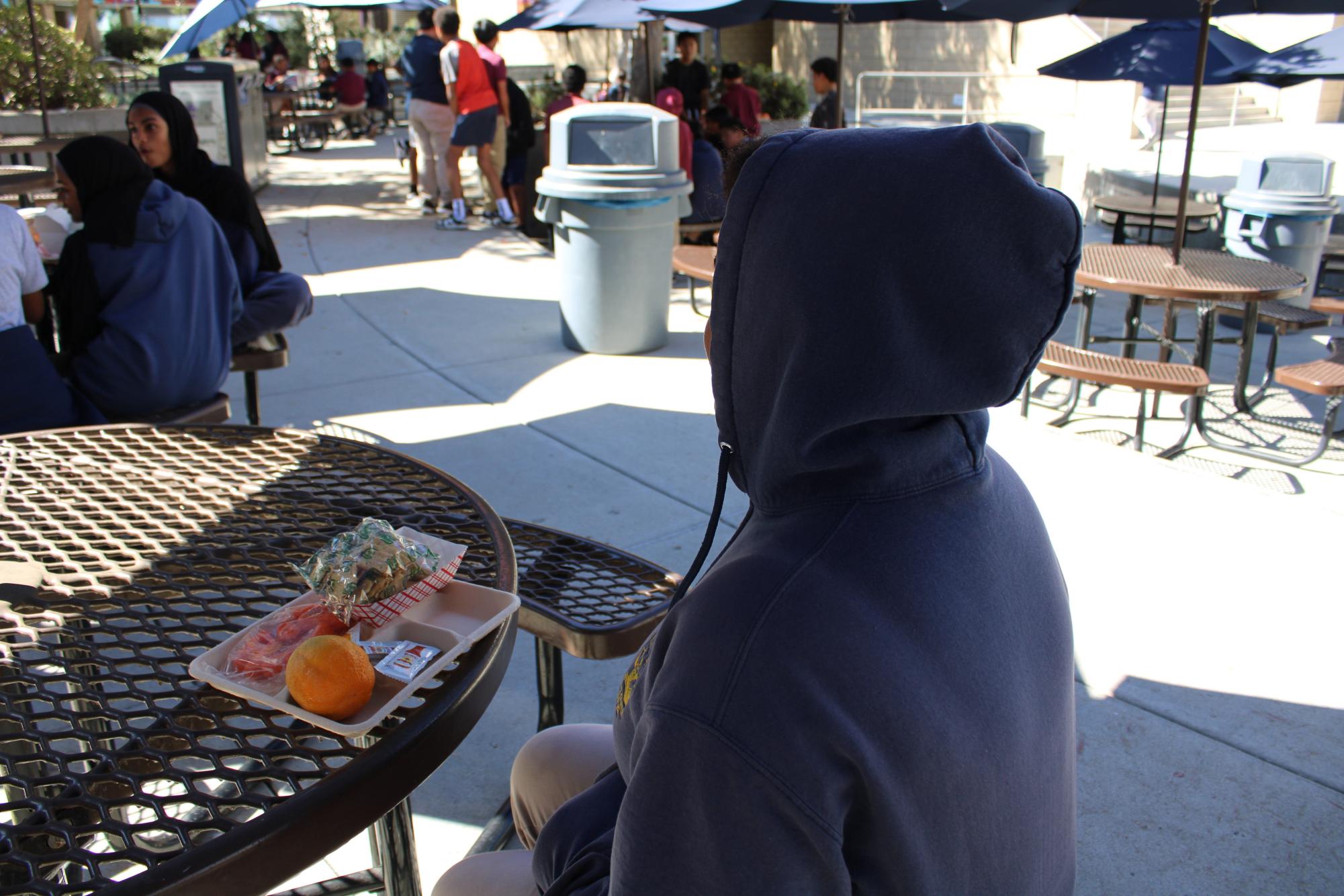 Student wearing their hoodie at lunch 