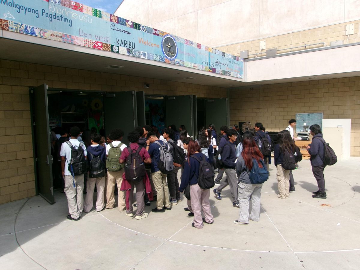 Preuss students are seen standing unorganized waiting for their lunch.