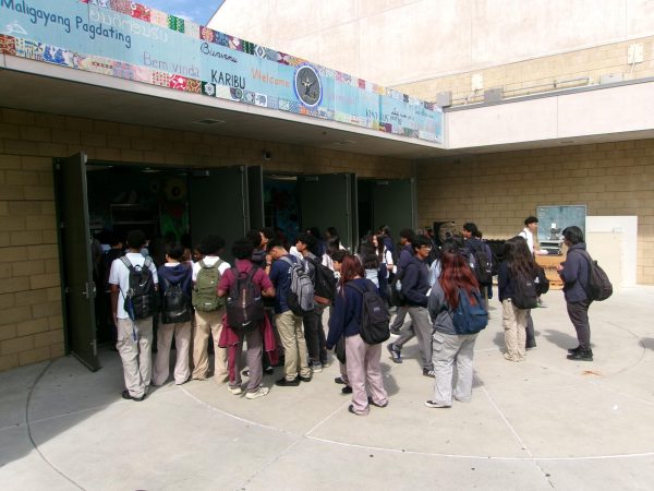 Preuss students are seen standing unorganized waiting for their lunch.