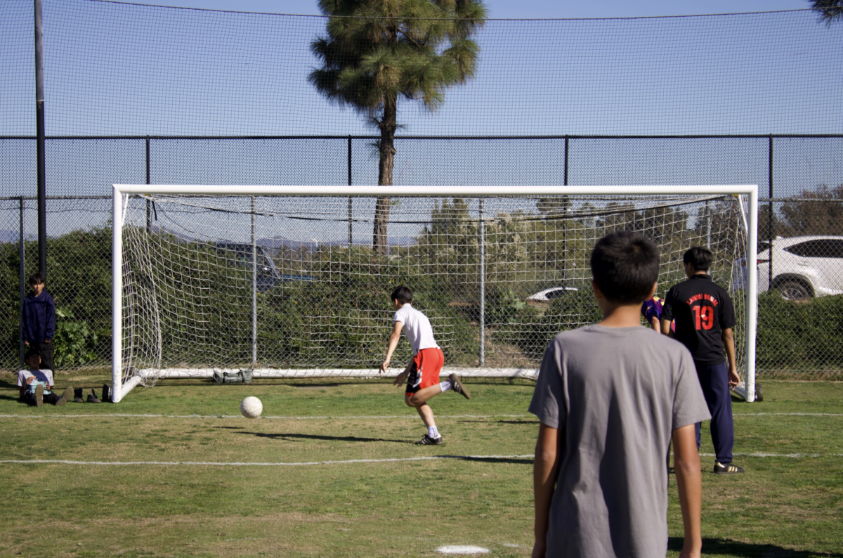 Student talking a free kick. 