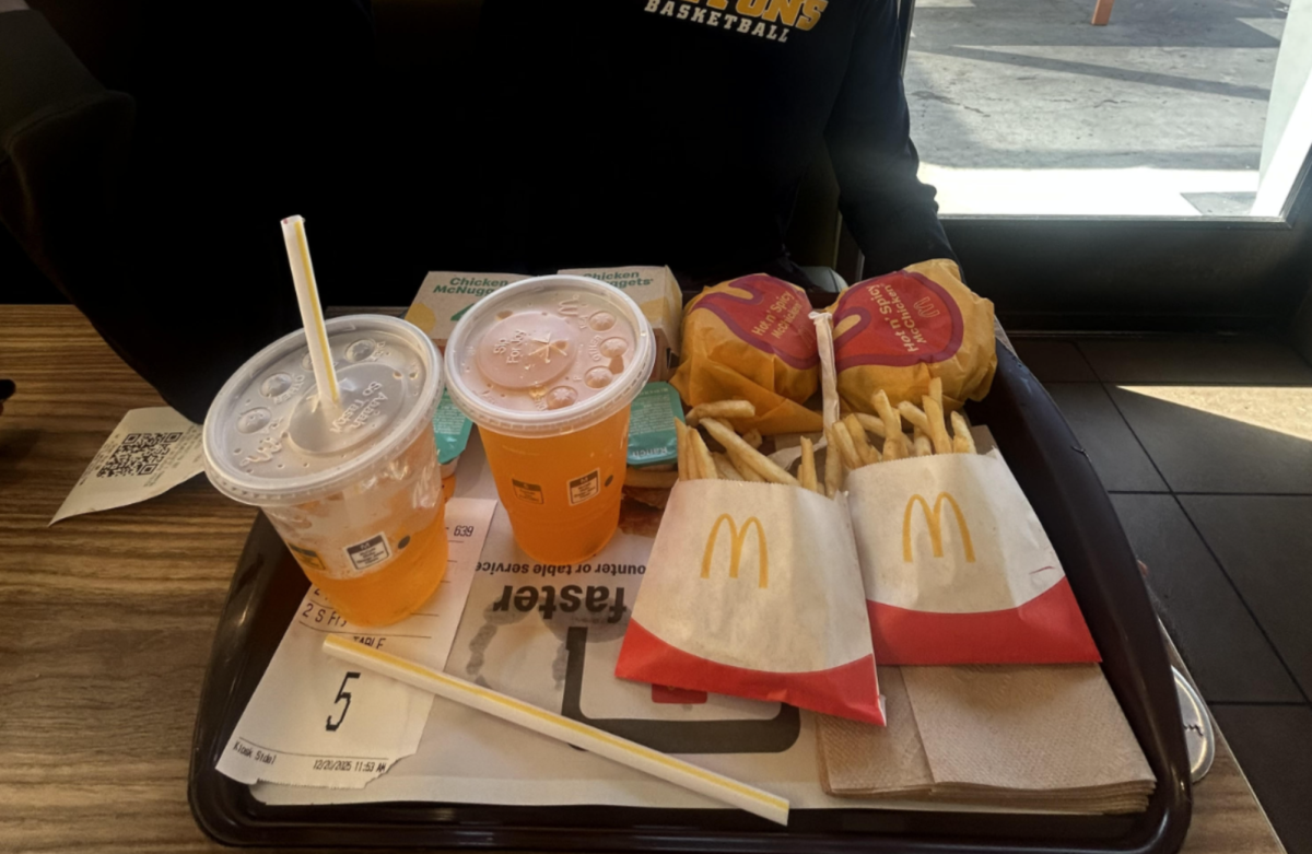 Student eating McDonalds after a Basketball Game