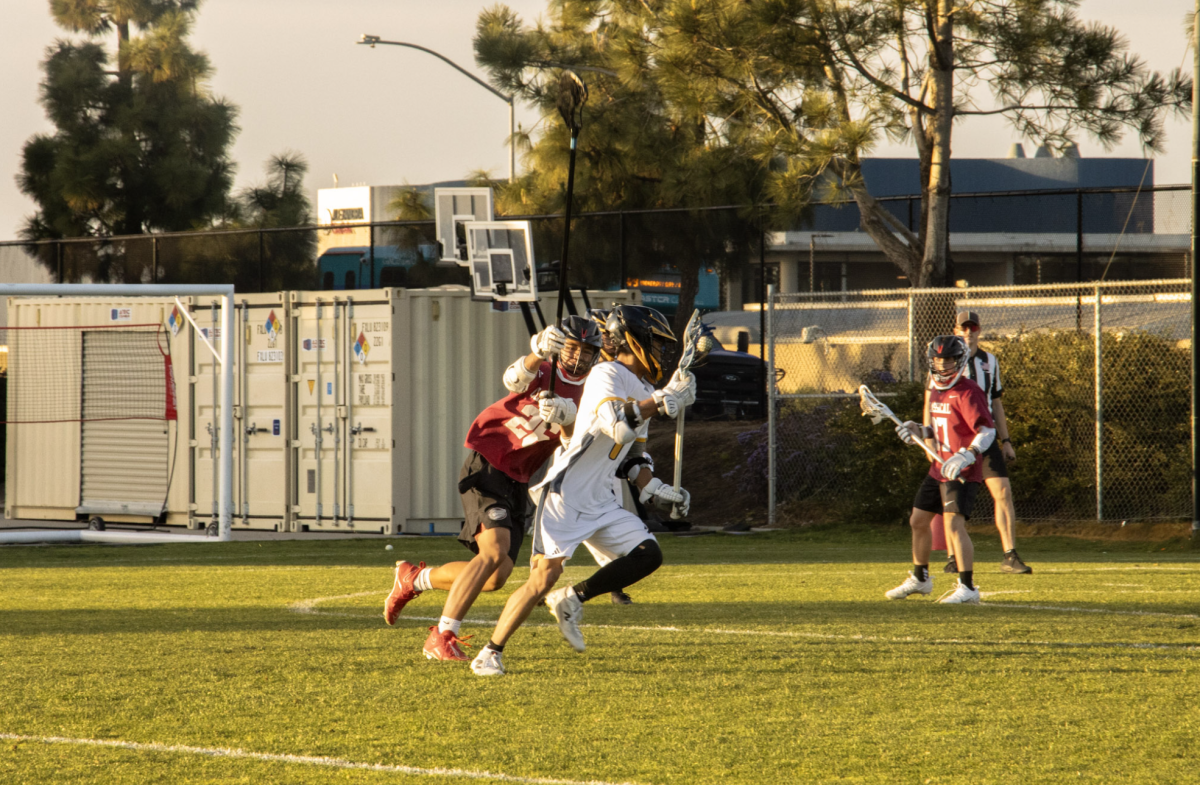 Boys's lacrosse player charges for a scoring attempt.