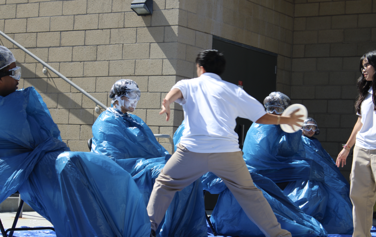 Junior pieing their friend during pi week