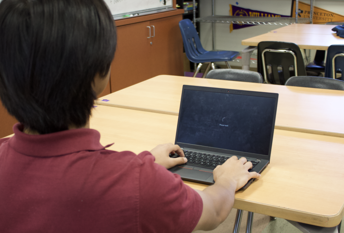 Student waiting for screen to load in order to sign in. 