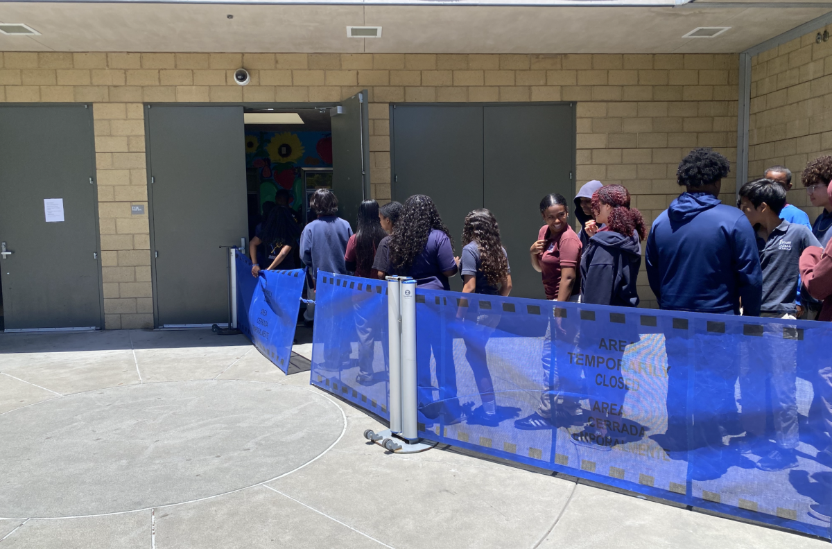 Middle School Students waiting in a long line to get lunch. 